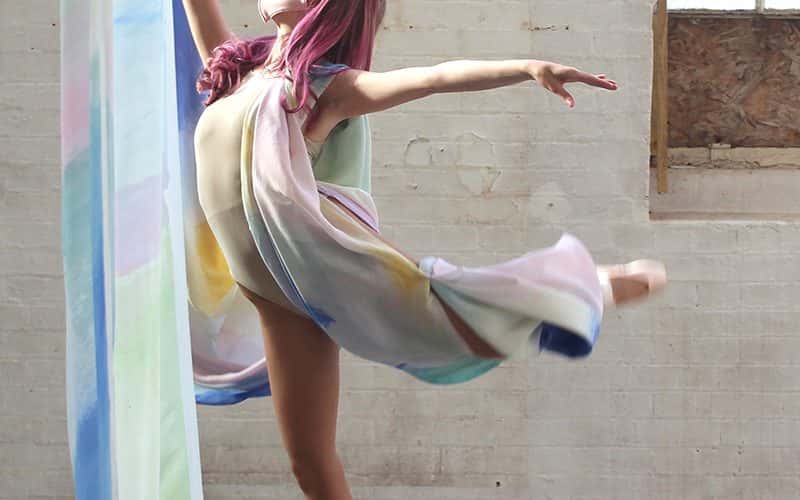 BA Fine Art work by Brooke Savino showing an installation view of a dancer amongst painted fabrics.