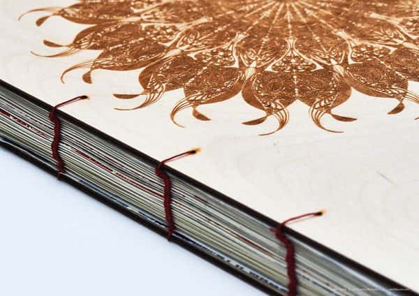 Emily Beavis - A thread bound book with thin plywood covers, and mandala pattern burnt into the cover