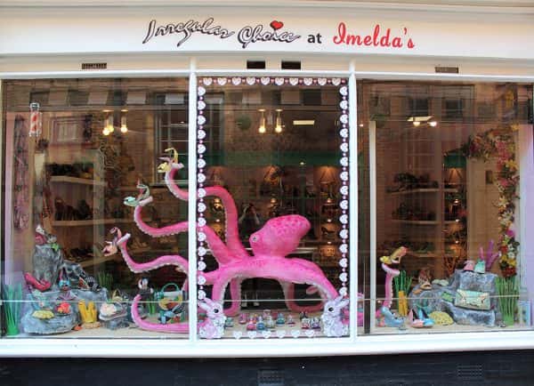 Katie Scott - A large model of a pink octopus in a shop window