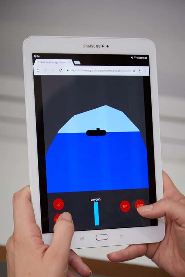 Submarine game prototype - Games development student testing a game on a tablet, a ship is on the horizon of an ocean, and the player is controlling a periscope to focus on it