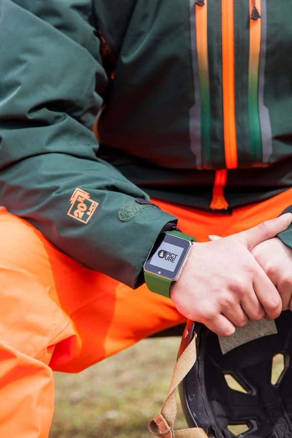 Daisy Green - Image of a male model wearing a green and orange jacked and wearing a smartwatch which is the focus of the shot