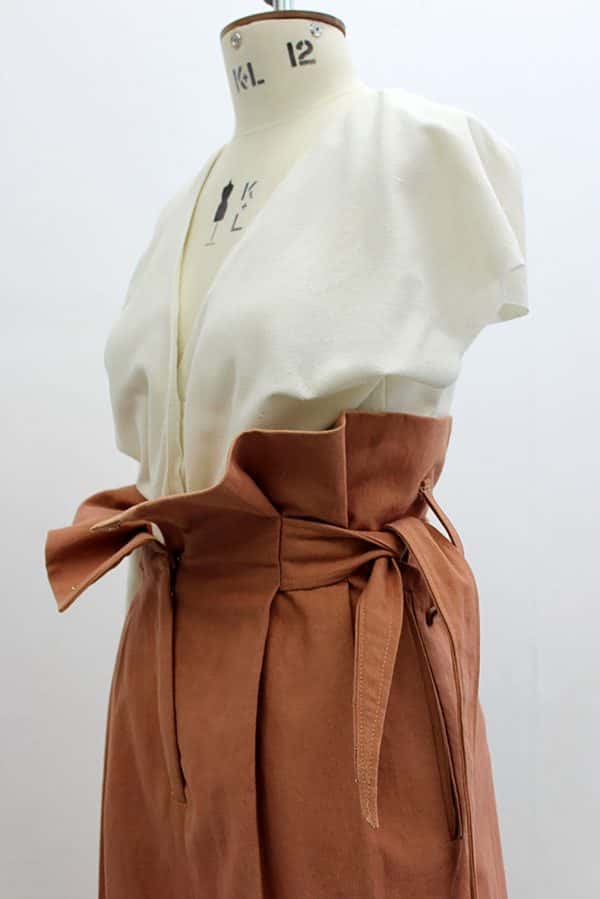 Hannamari Markkula - relaxed fit off white blouse with a low neck to buttons, and brown paper-bag top skirt with tie fastening