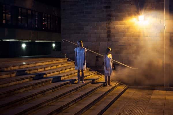Jensdottir Gudbjorg - People standing at a distance on different steps in a concrete courtyard area