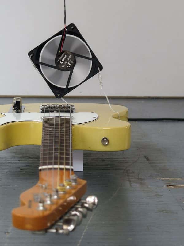 Megan Ryder - An electric guitar with a computer fan mounted on it to blow along it's strings