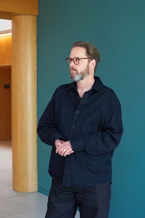 Staff portrait of Liam Wells wearing a black shacket and black jeans