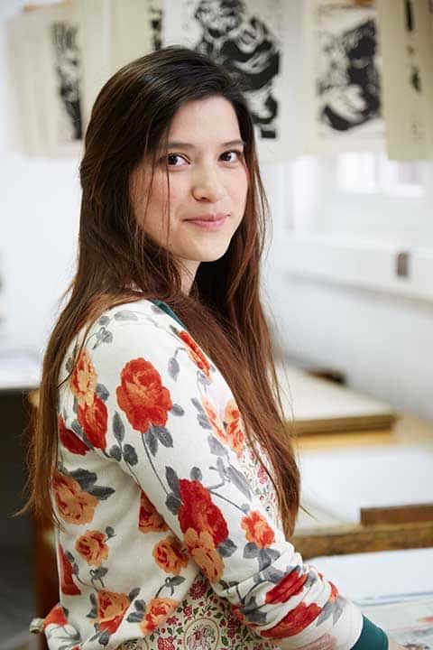 Karla Martinez at Norwich University of the Arts in studio in flowery top