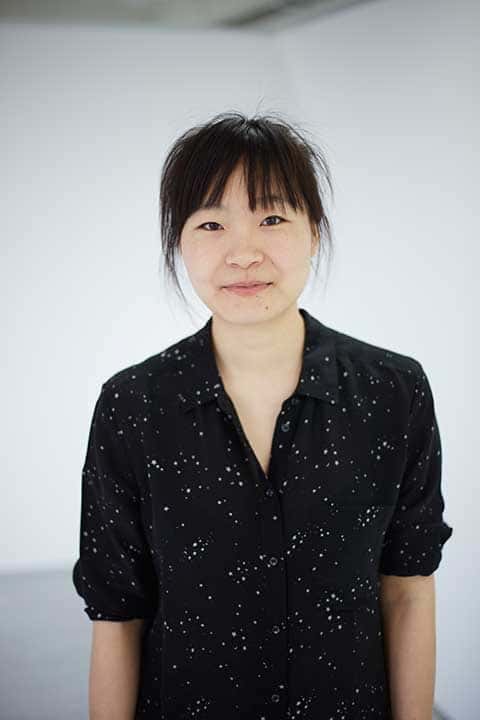Yu Miao Fashion student in the Norwich University of the Arts fashion studio in black top