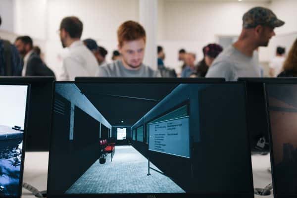  - Photograph from BA Degree Show 2017 with close-up screens in the foreground and out of focus people behind