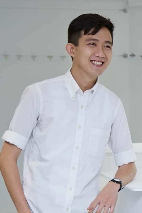 Mark Ng wearing a white shirt and smiling