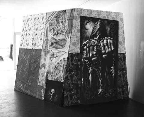 Timber architectural structure, bedsheets, funeral t-shirt, digital print - Installation by Matthew Benington of a large timber syrucyure covered with fabrics printed digitally