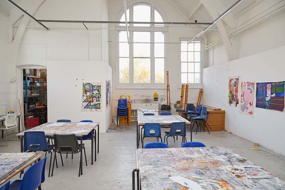Fine Art Painting Studio at Norwich University of the Arts, showing a creative painting space including chairs and easels by a window