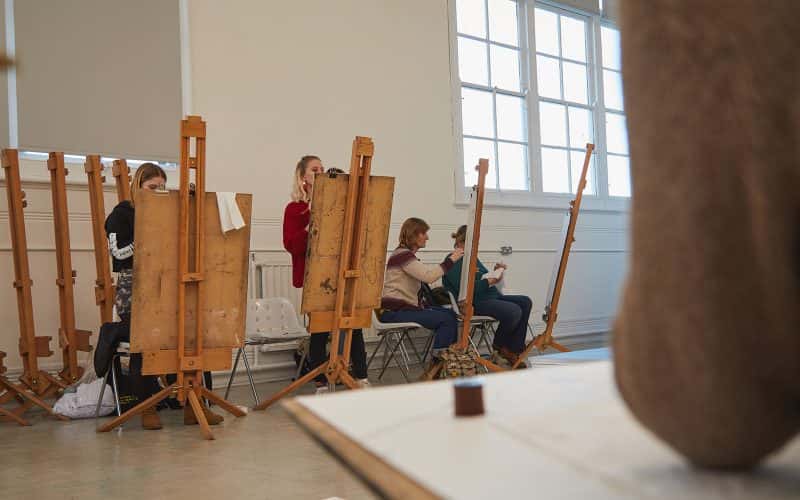 Students work on easels in Munnings Drawings Studio at Norwich University of the Arts