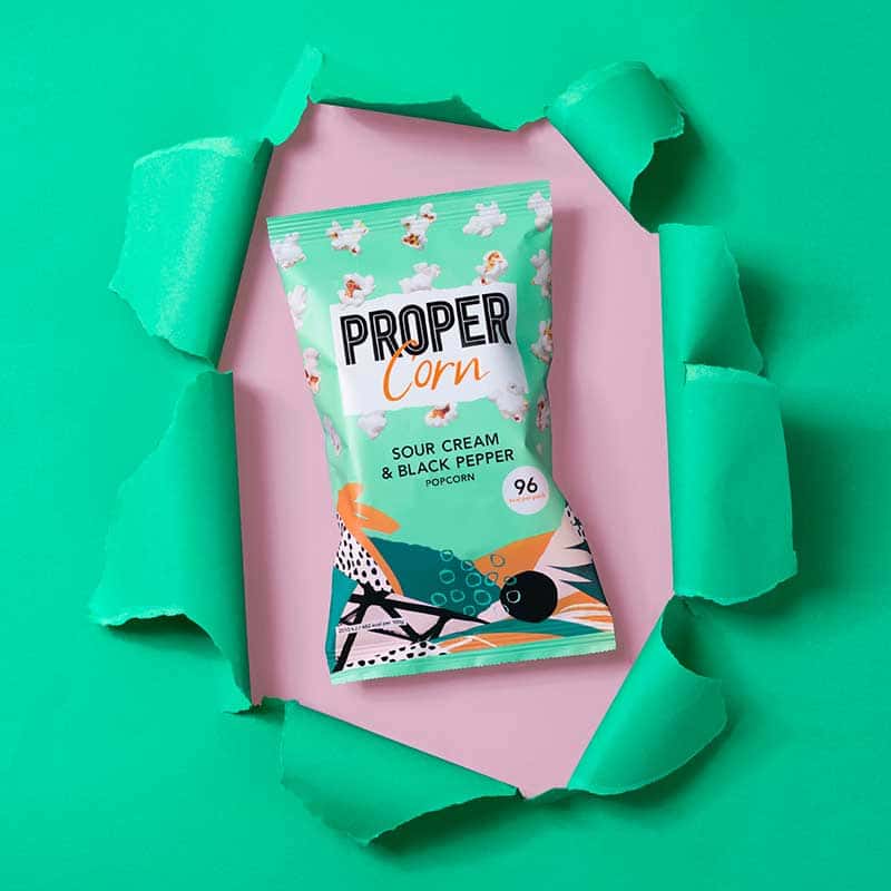 Propercorn designed by BA Illustration graduate from Norwich University of the Arts, Tom Abbiss Smith showing green bag of Popcorn