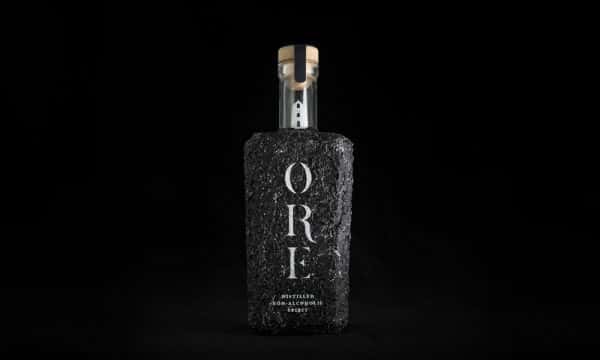 Tom Hardwick - Non-alcoholic spirit bottle design for 'Ore'. The bottle is made out of black ore, and has a rough, hard texture. In the bottle stem is a miniature lighthouse, to represent Cornwall where the drink is made