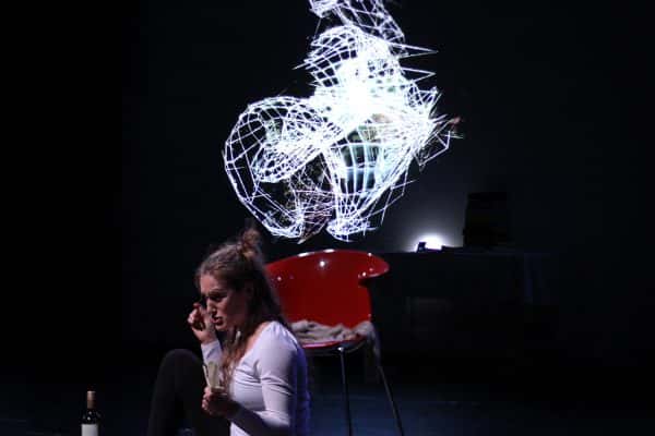 Jamie Gledhill - Image shows a large 3D white wireframe above a womans head, the woman has balled fists