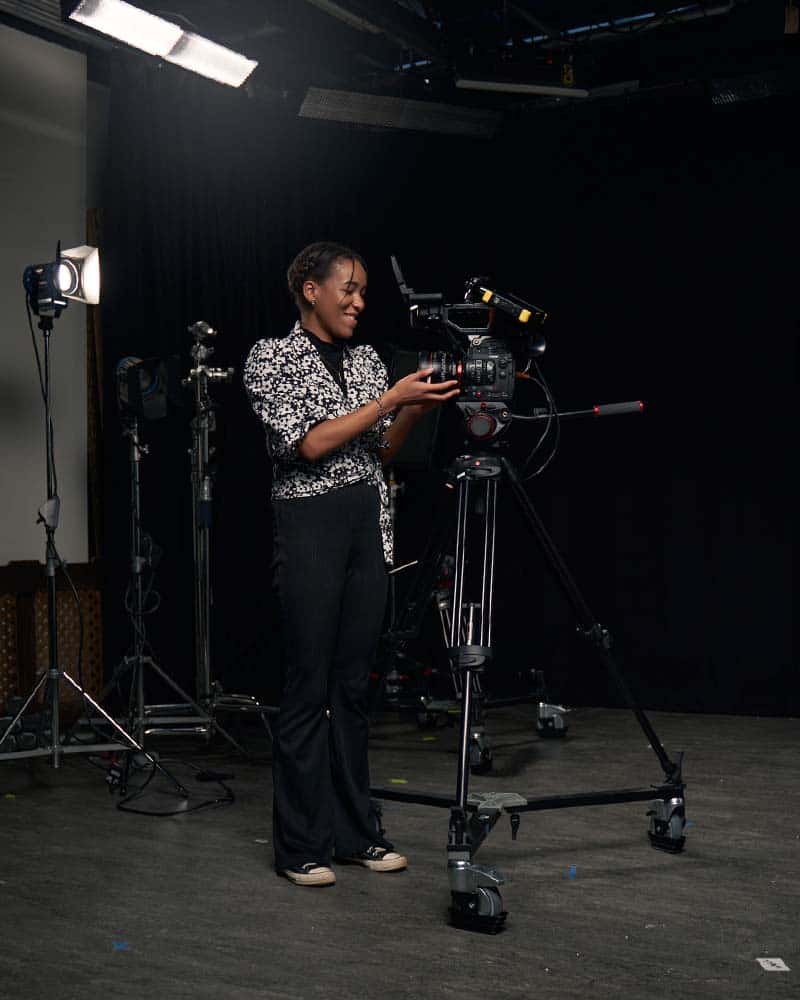 Student Tanicha uses a camera rig on wheels in the NUA Film Studio