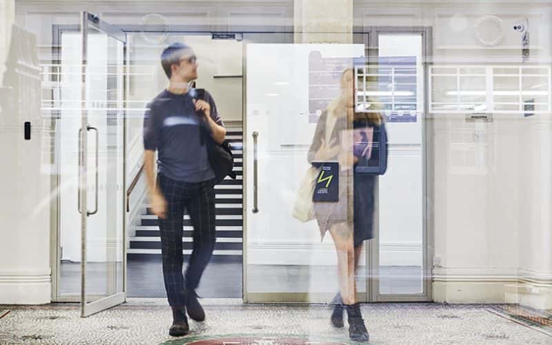 Image showing to people in foyer of building carrying bags
