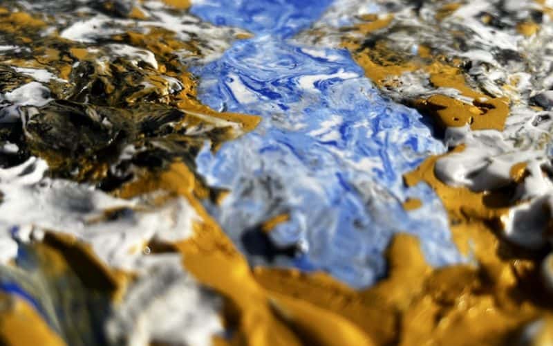 Image of close up of painting made with plaster and acrylic with blue and gold textures