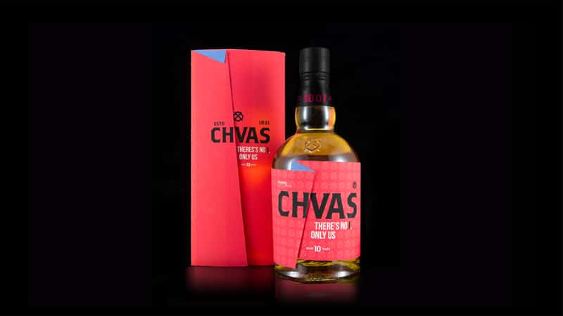A photograph of a CHIVAS Regal whiskey bottle and the box packaging placed behind it. The bottle label has been folded over the I in CHIVAS as well as on the packaging.